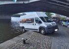 Emergency crews secure van suspended above riverbank